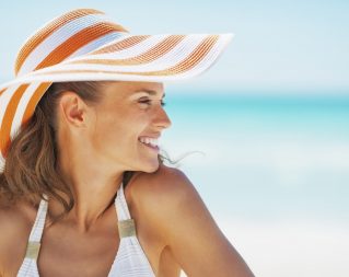 Woman in a sunhat on the beach